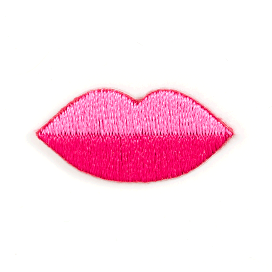 A bright pink embroidered patch shaped like lips, shown on a plain white background.