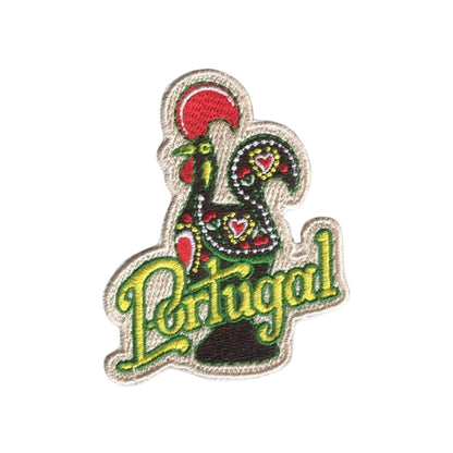 An embroidered patch featuring a traditional Portuguese rooster in red, green, and black with the word 'Portugal' in green script below it, on a plain white background.