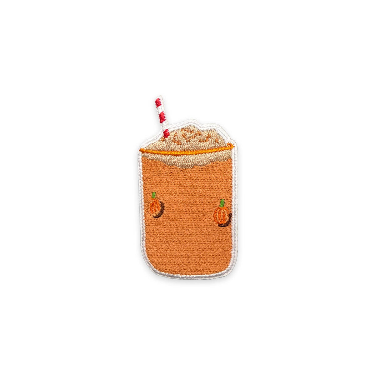 An embroidered patch shaped like a pumpkin spice latte, featuring a textured orange body, a white foam top, a red and white striped straw, and small embroidered orange pumpkins on the front, set against a plain white background.