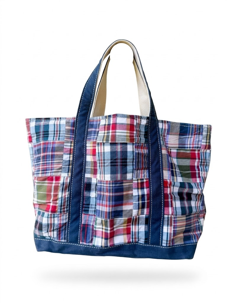Vintage L.L. Bean patchwork madras canvas tote bag, medium shoulder tote size with red blue green plaid pattern and navy canvas handles isolated on white