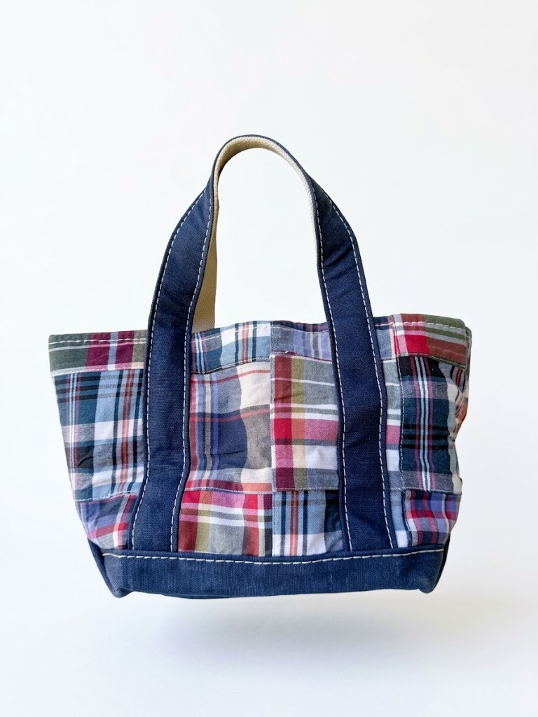 Vintage L.L. Bean patchwork madras canvas mini tote bag, mini handbag size with red blue green plaid pattern and navy canvas handles isolated on white.