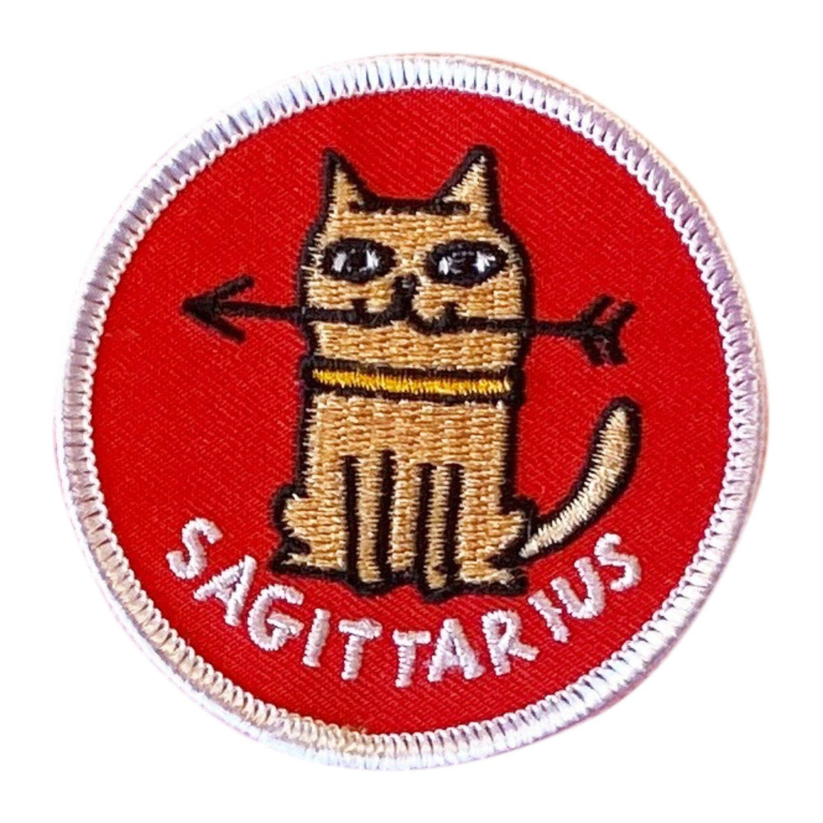 Embroidered patch with a cat holding an arrow and 'Sagittarius' text on a red background
