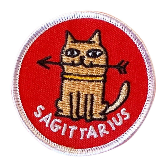 Embroidered patch with a cat holding an arrow and 'Sagittarius' text on a red background