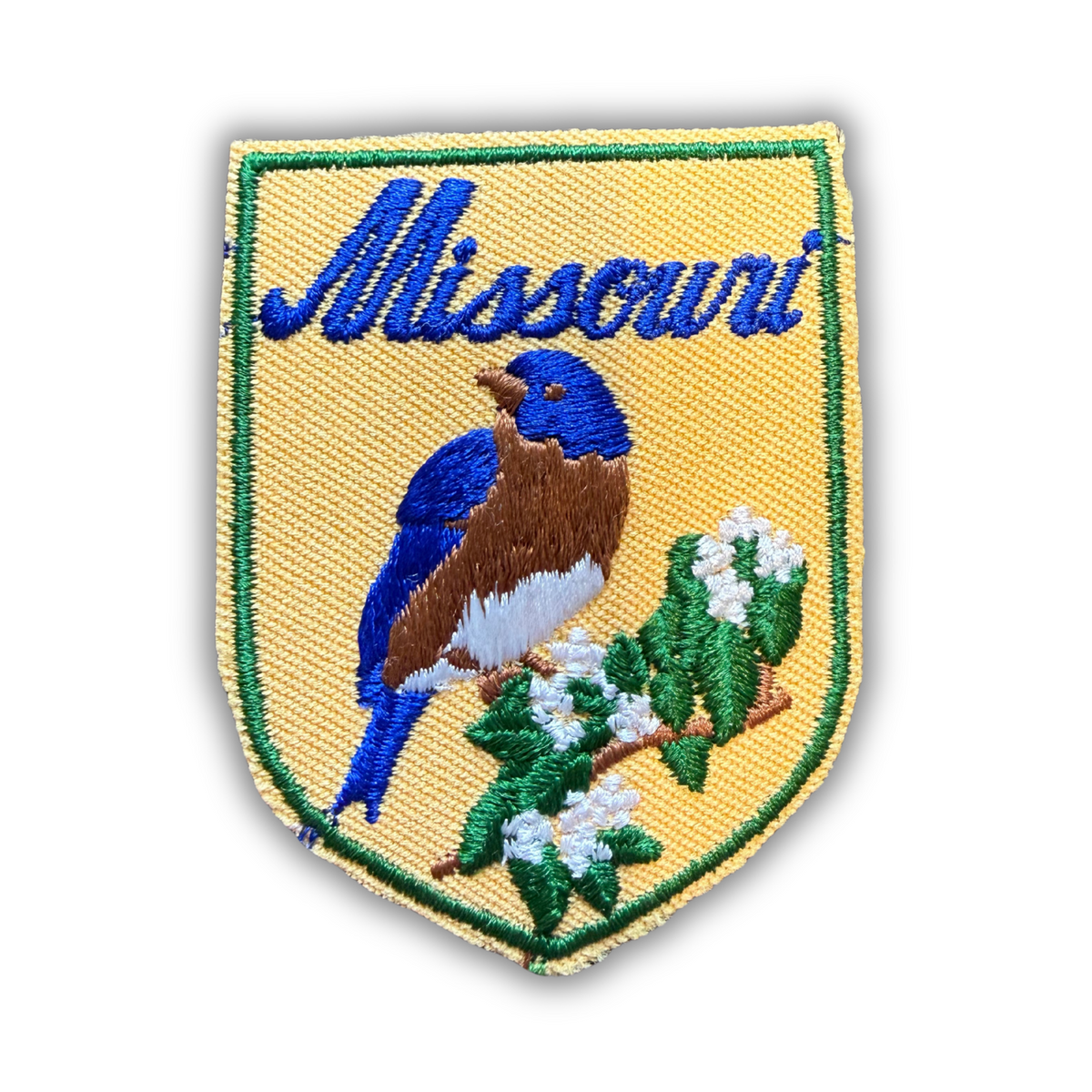 Vintage Missouri embroidered shield patch, bluebird on white hawthorn blossoms, yellow with blue script