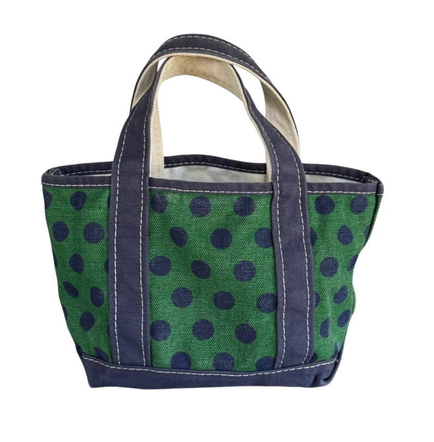 Mini vintage L.L. Bean Boat and Tote bag in vibrant emerald green canvas with a deep navy blue polka dot pattern, featuring dark navy handles, bottom trim, and white contrast stitching isolated on a plain white background.