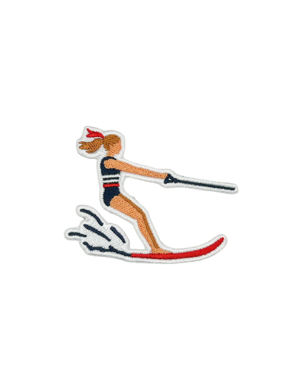 An embroidered patch depicting a woman wakeboarding, shown on a plain white background.
