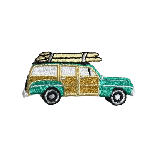 Embroidered patch of a vintage car with luggage on a white background